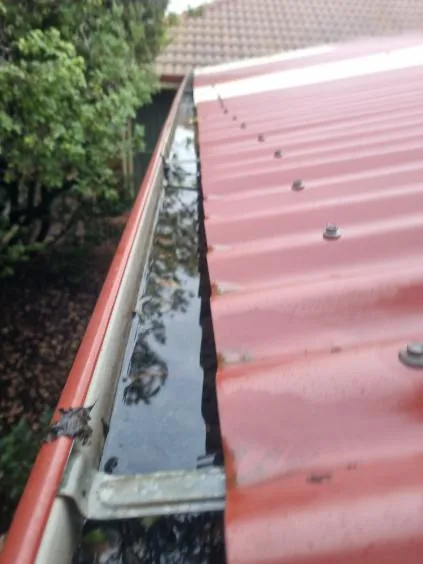 A clean red-tile-roof gutter after a professional clean